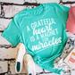 Magnet For Miracles Tee